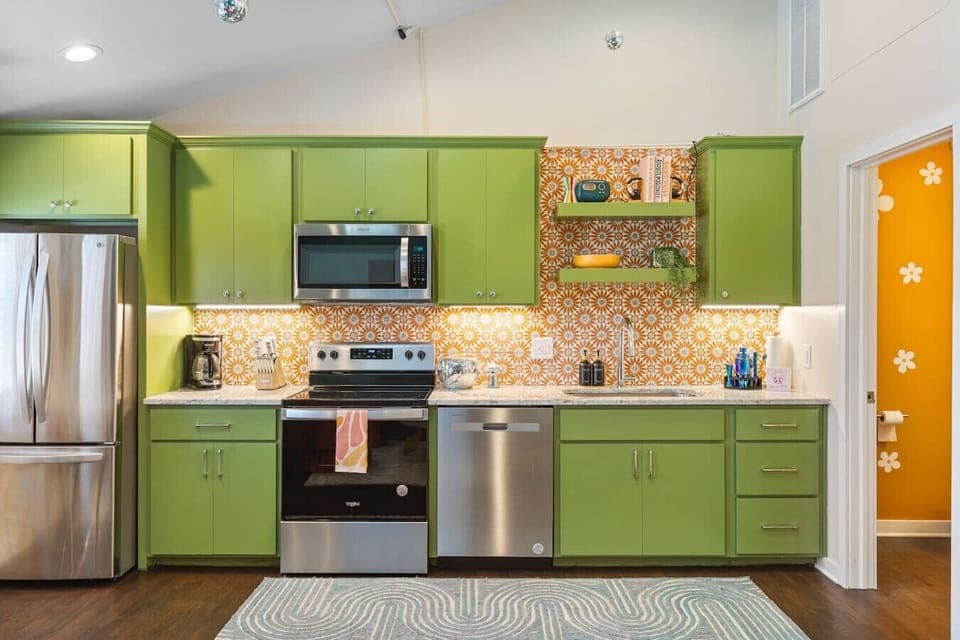Fully equipped kitchen with all your cooking essentials, drip coffee maker + coffee. Dining table with seating for 2. This room opens up into the living room. Bold colors, bright lights and decor all throughout the condo.