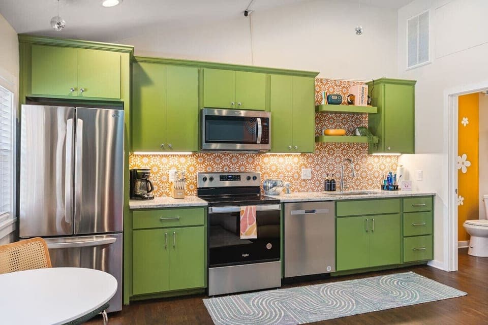 Fully equipped kitchen with all your cooking essentials, drip coffee maker + coffee. Dining table with seating for 2. This room opens up into the living room. Bold colors, bright lights and decor all throughout the condo.