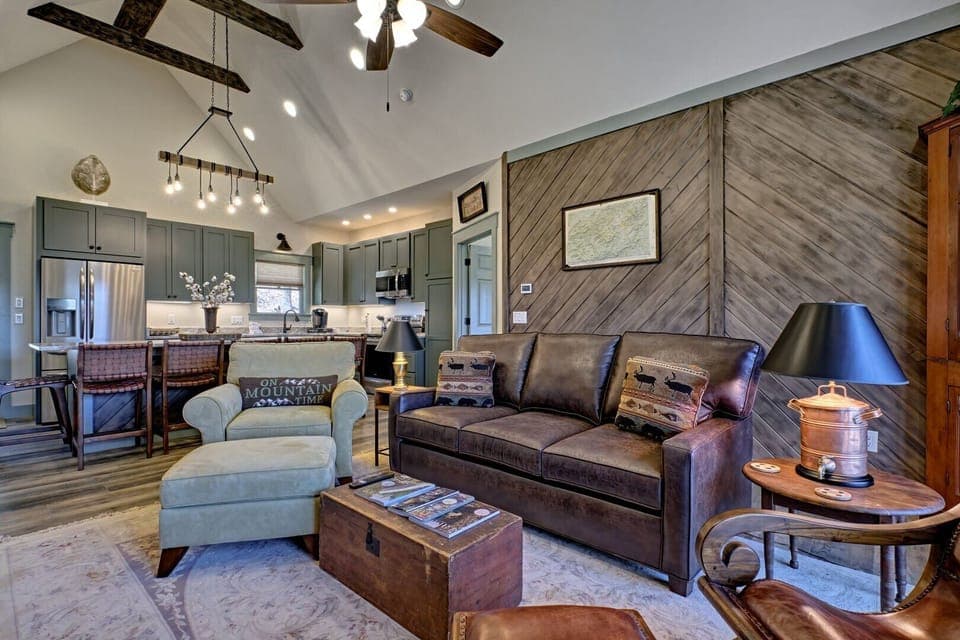 Living room with pullout sofa bed, Kitchen area and doorway to queen bedroom