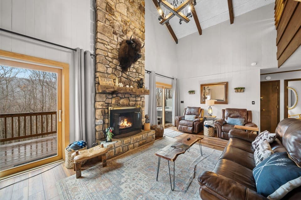 Leather Furniture and Stacked-Stone Fireplace with Mountain Charm