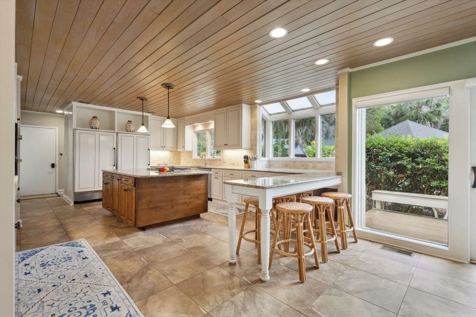 Step into this warm and inviting kitchen, where natural wood tones and soft lighting create the perfect holiday retreat.