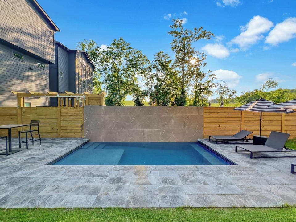 Backyard: Soak up the sun and enjoy a dip in our inviting shared pool area. Backyard and pool is shared with guests staying in the upper floor unit.