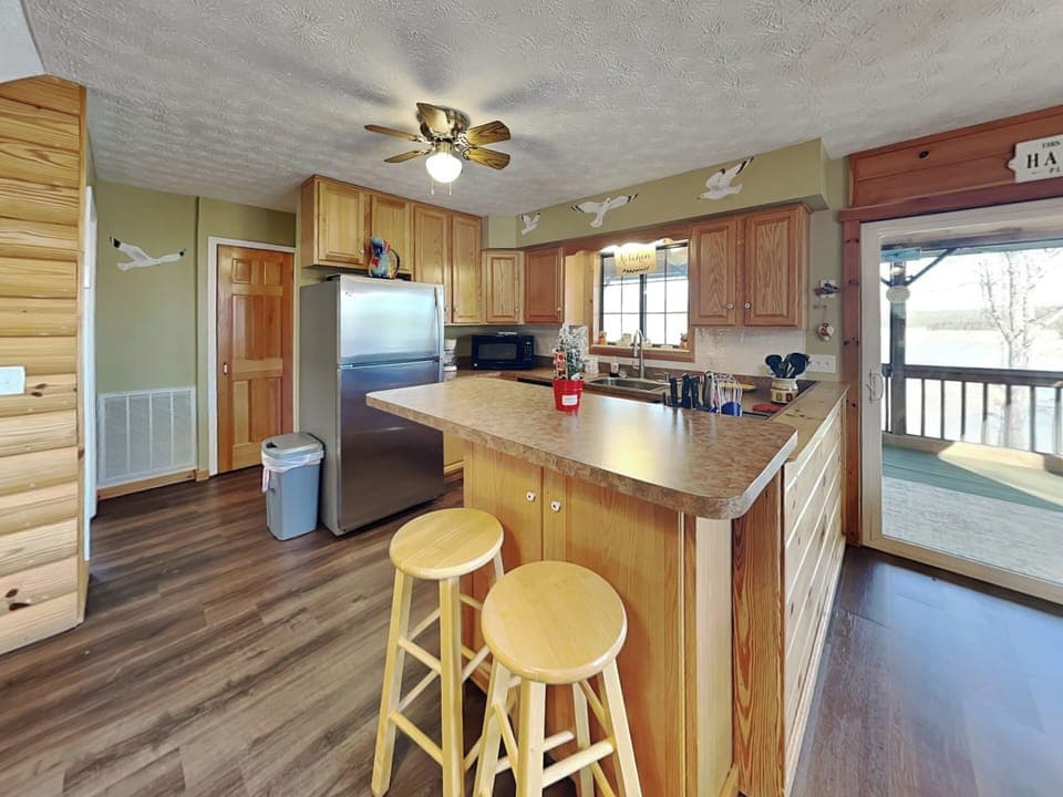 Fully Equipped Kitchen with Stainless Steel Appliances and Breakfast Bar Seating for Two - First Floor