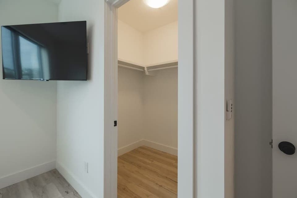 Bright and stylish bedroom with two cozy beds, modern decor, and an en-suite bathroom.