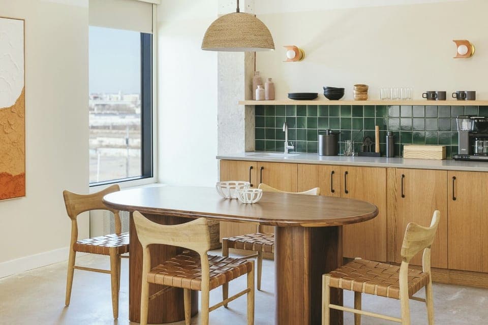 Gather for morning coffee at the warm, modern table.