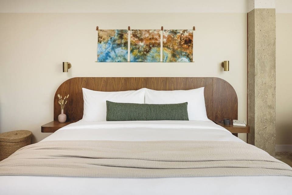 Drift off beneath warm wood tones and calming art.