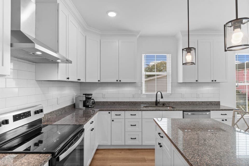 Cook memorable meals in your spacious kitchen featuring modern appliances, and elegant pendant lighting.