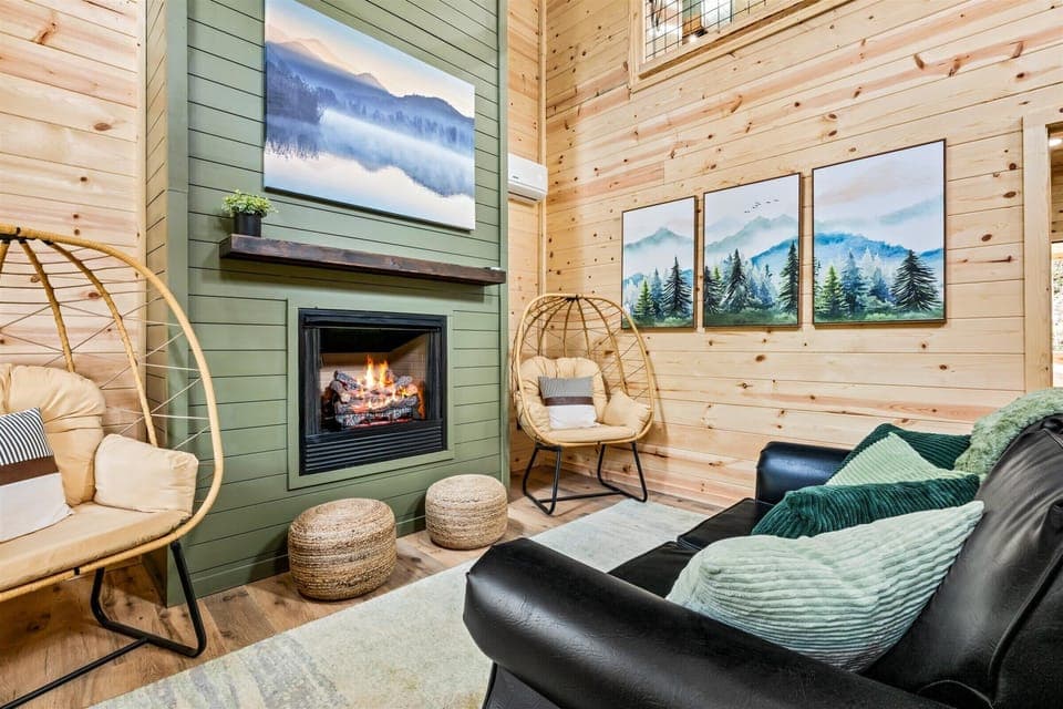 Cozy retreat with green accents, warm wood paneling, and a stand-mounted egg chair.