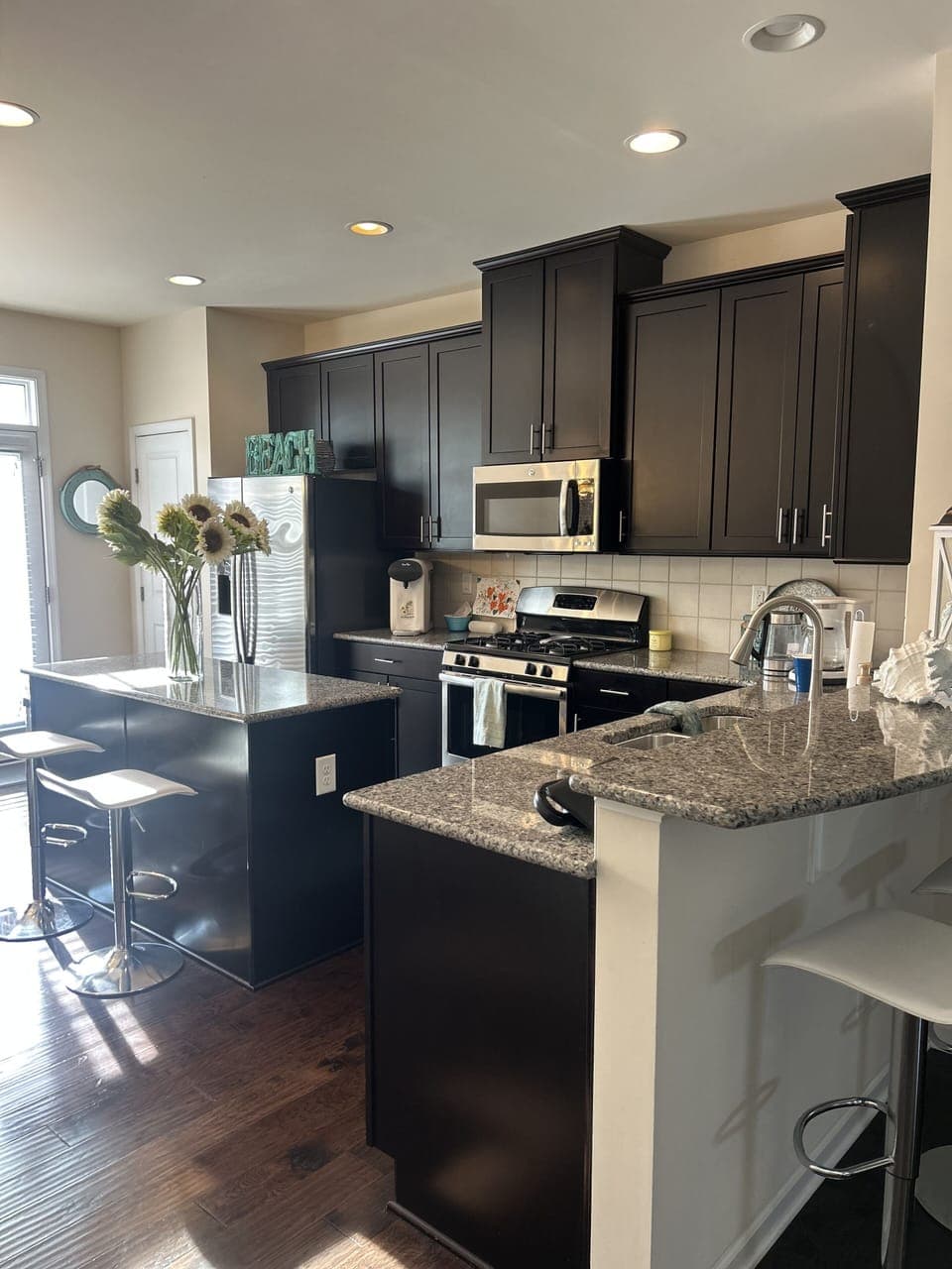Kitchen with gas stove, microwave, dishwasher, coffee pot.