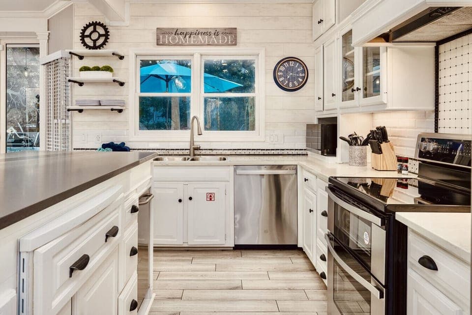 The kitchen also has a double oven range, a second dishwasher, a microwave and an under the counter ice maker. Open up the cabinets to find pots and pans, cooking utensils, flatware, dishes, and small appliances to fix delicious meals.