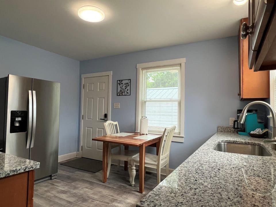 Kitchen with side by side fridge and freezer, back door to patio.