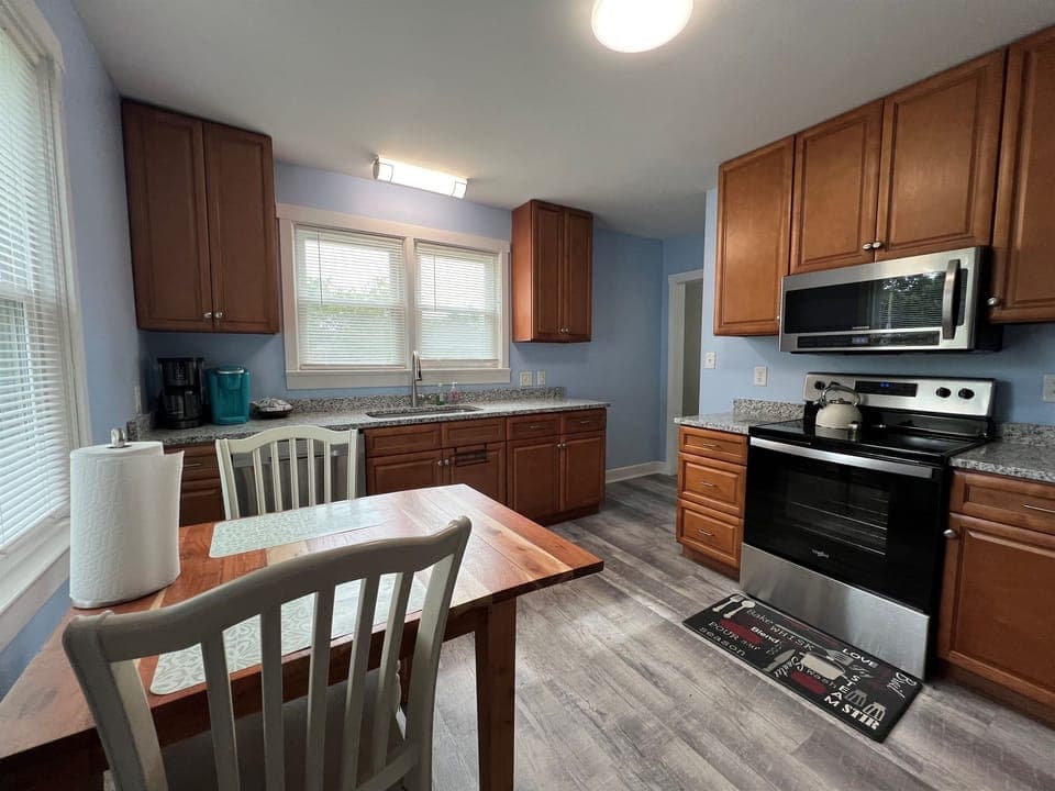 Full kitchen with stove, microwave, large sink.