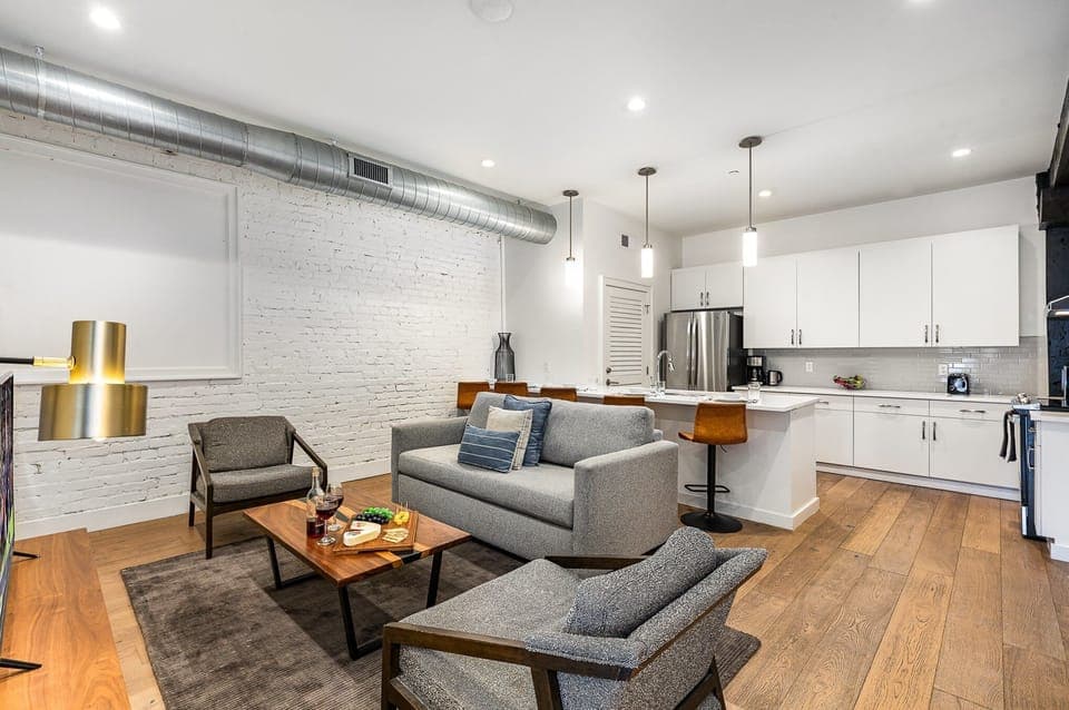 Unit 1: Open-concept living area featuring cozy furnishings, smart TV, and a sleeper sofa. (4th Floor)