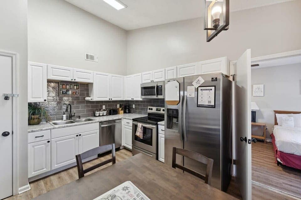 Bright white kitchen with modern appliances and clean lines. Plenty of counter space and storage.