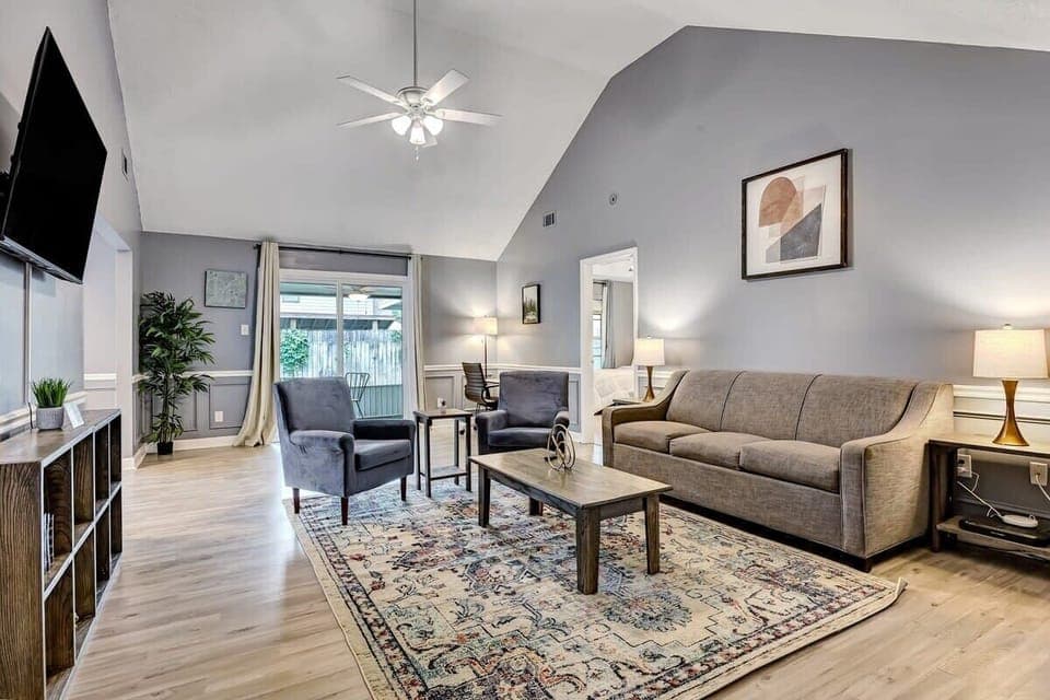 Bright living room with plush seating, vaulted ceilings, and plenty of natural light.