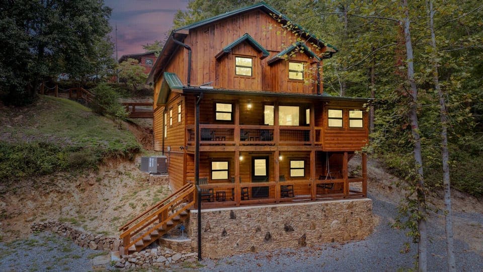 Rustic Mountain Cabin Exterior | Three-Story Log Home with Wraparound Porches and Stone Foundation