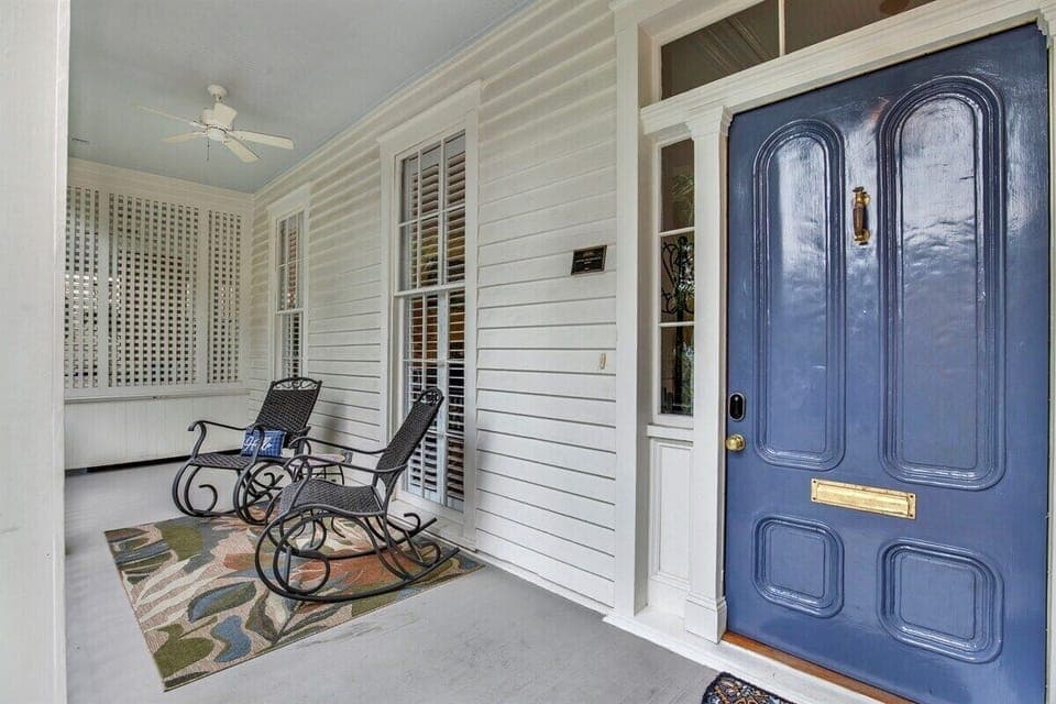 Cozy front patio with two chairs—perfect for morning coffee or evening chats.