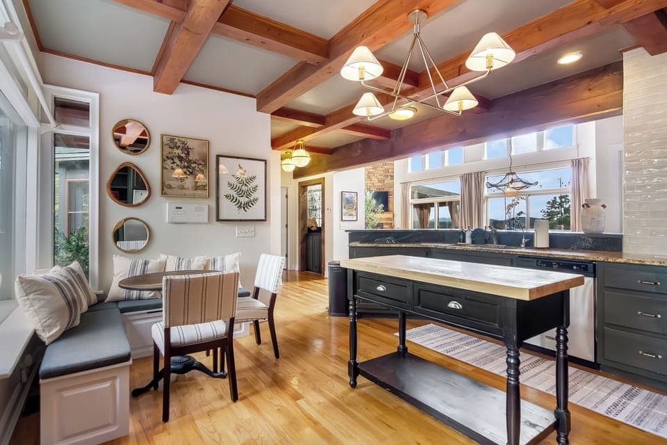 Bright kitchen with breakfast nook, butcher block island & sunny views!
