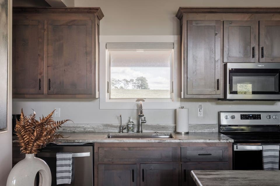 Modern kitchen with farmhouse sink, wood cabinets, and plenty of space for preparing meals.