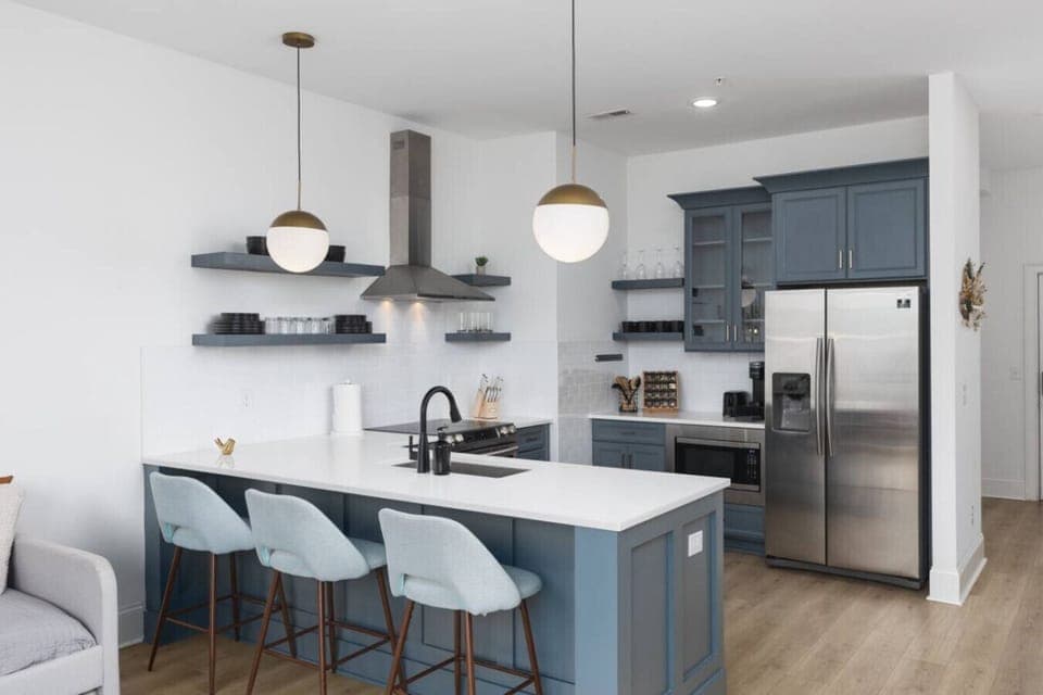Condo 1 - Fully-stocked kitchen for all your cooking needs! There is also a separate high-top dining table with seating for 4.