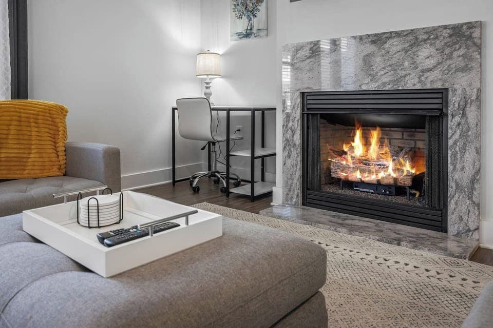 A dedicated desk corner paired with a fireplace makes working from home warm and inviting.