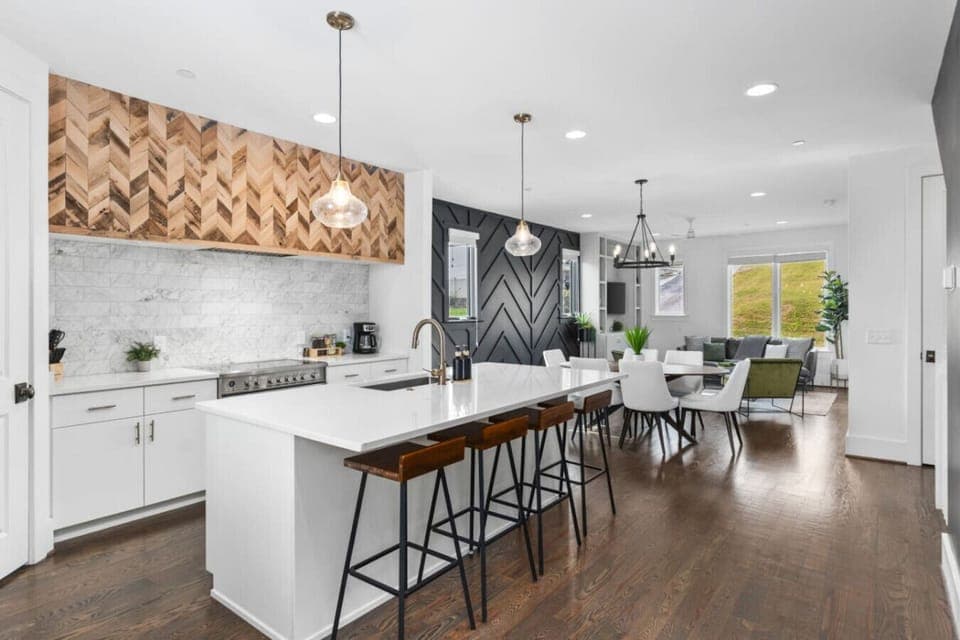 High-end appliances, large pantry, and all the cooking supplies you might need in this bright & fresh kitchen with seating for four at the island.