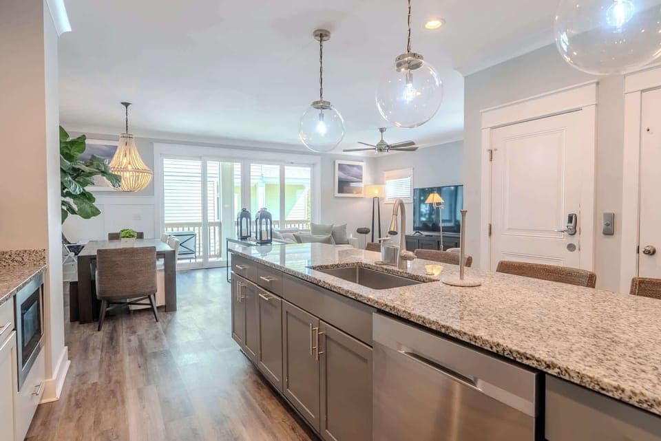 Bright, fully equipped kitchen with an island and seating, perfect for cooking and gathering.