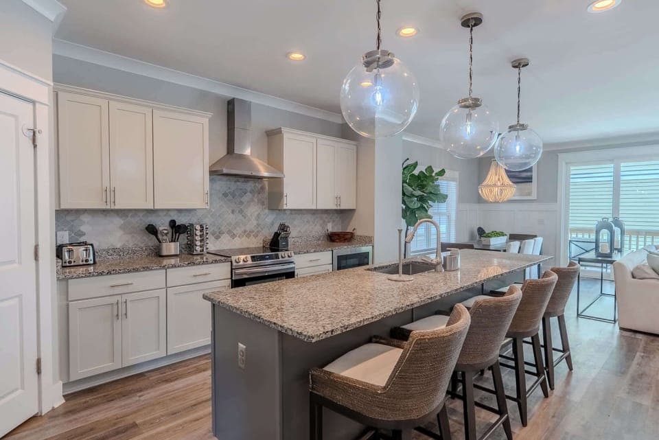 Modern, open kitchen with updated appliances and an island featuring bar seating.