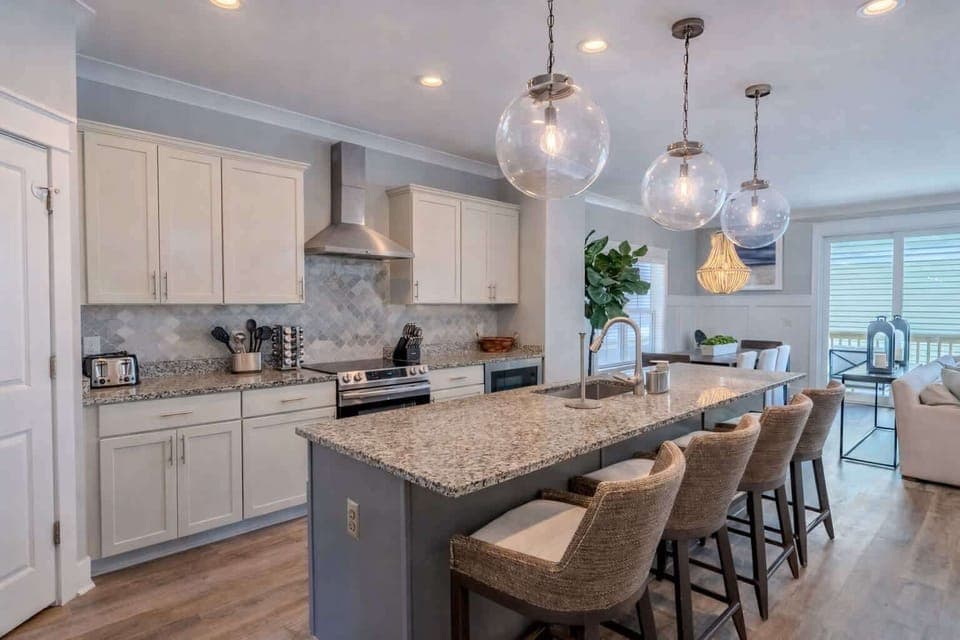 Modern, open kitchen with updated appliances and an island featuring bar seating.