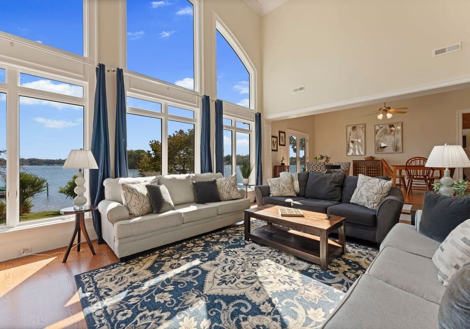 Main sitting area with living room. Three, three seater couches, with wall of windows and TV!