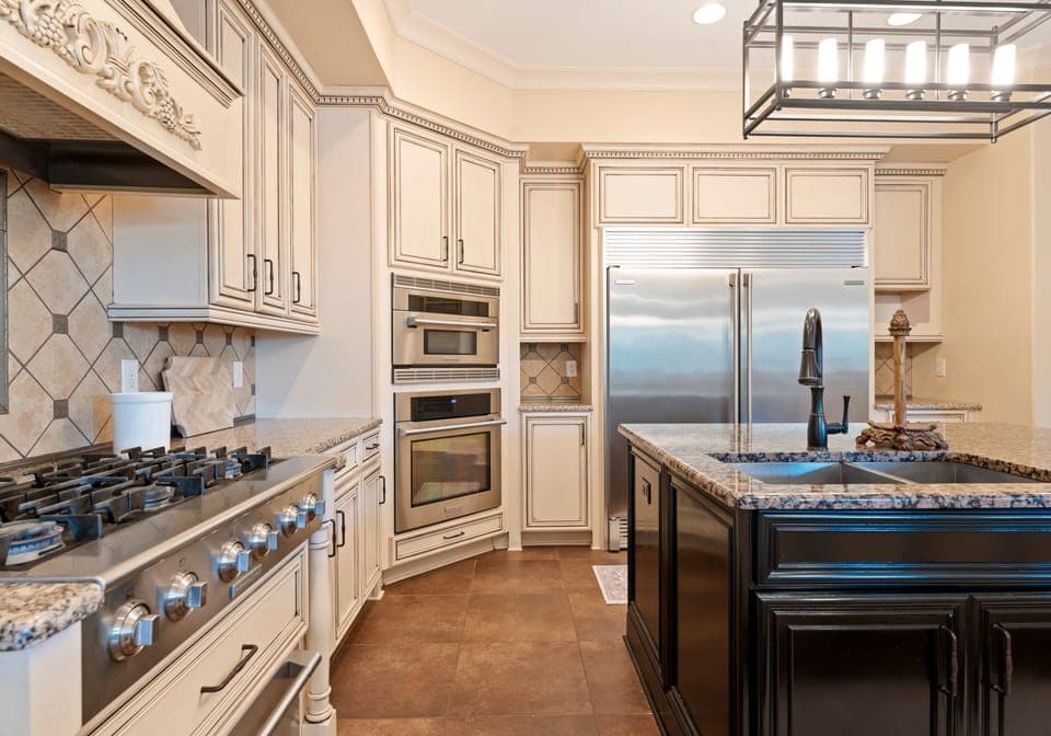 Fully stocked kitchen with island and bar seating.