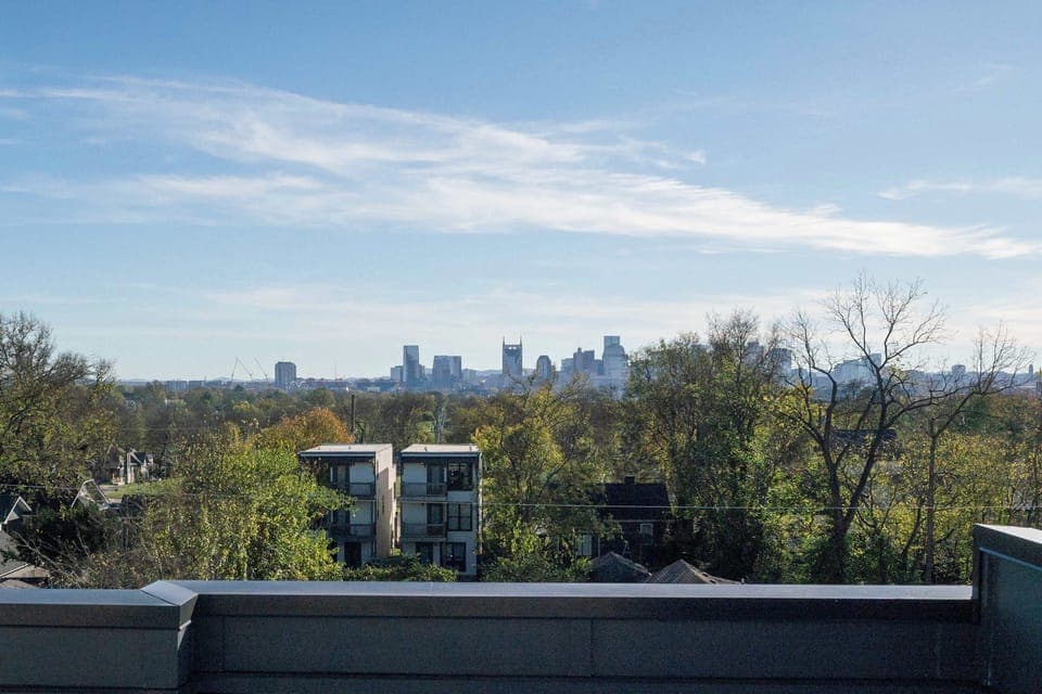 Enjoy your morning coffee on a private rooftop deck with stunning Nashville skyline views. This luxurious retreat is ideal for large groups seeking an upscale experience in the heart of Music City, just moments from downtown!