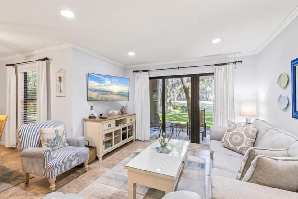 Large sliding glass doors opening to a private balcony view.