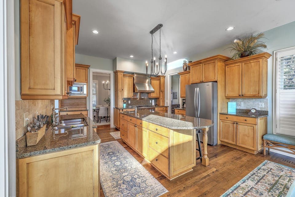 Large granite island for gathering and shared family meals.