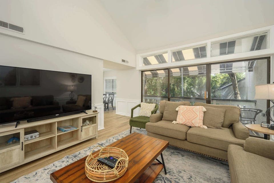 Sunlit and spacious living room with access to the private balcony