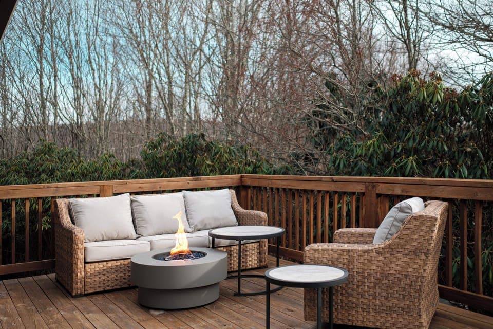 Gather on the spacious deck with cushioned seating and a modern fire table. A comfortable space for morning coffee or evening conversations under the North Carolina sky.