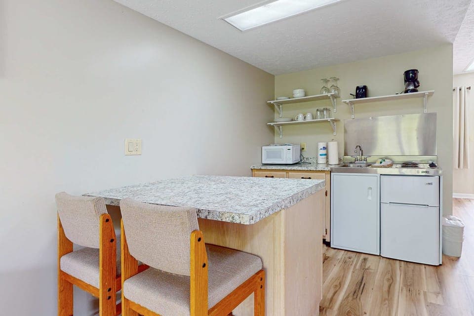 Modern design with granite island and essentials for meal prep and coffee breaks!