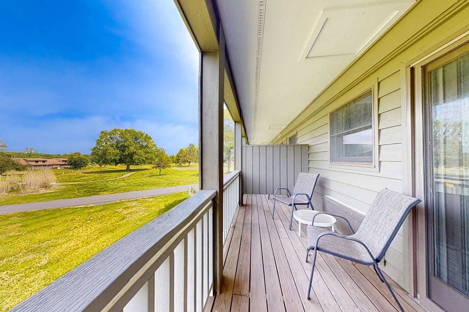 Private covered balcony with comfy seating & lush views. Perfect for coffee, sunsets & fresh air. Quiet resort-style stay, scenic overlook, couples retreat, long stays, near lakes.