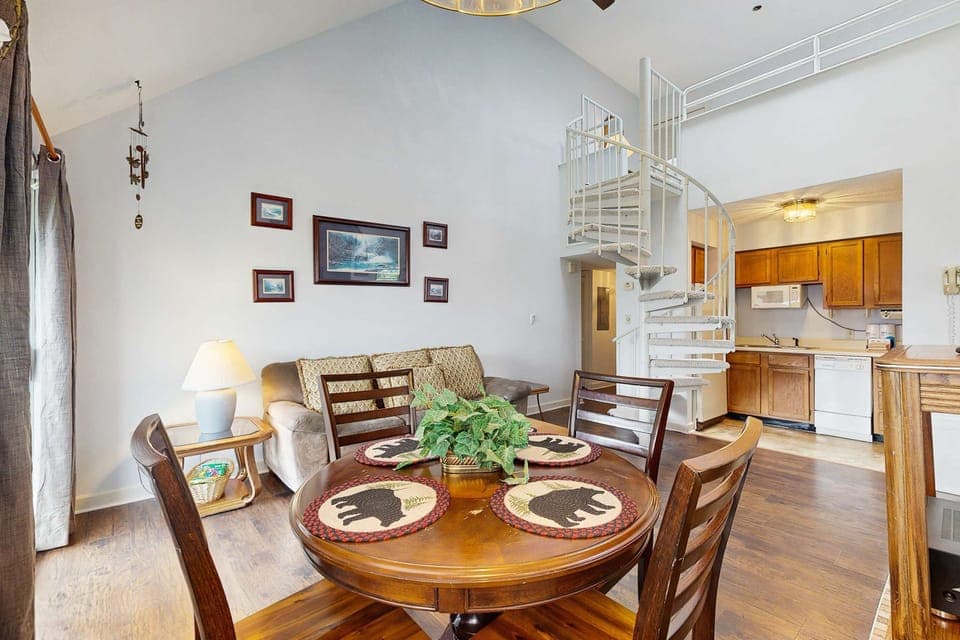 Bright, inviting space with spiral staircase, plush seating, and playful bear decor!