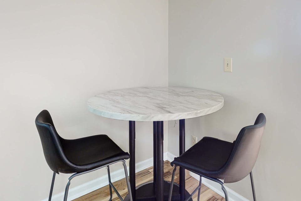Bistro table for two, great for meals, coffee, laptop work, or games. A cozy touch for couples and extended stays in this convenient, comfortable space.