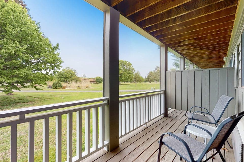 Private covered balcony with chairs and sweeping views. Relax with morning coffee, fresh air, and sunset skies; quiet outdoor space for couples, friends, and weekend escapes.