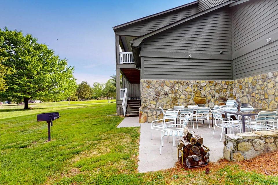 Large shared outdoor patio with seating and grill. Perfect for cookouts, groups, and family gatherings. Enjoy green space, fresh air, and shared community amenities. Studio retreat, outdoor dining, BBQ area.