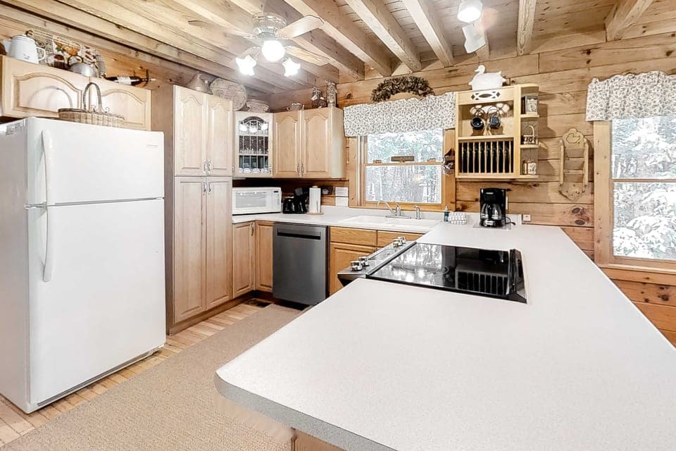 Whip up culinary delights in this charming space with wood beams and nature views!