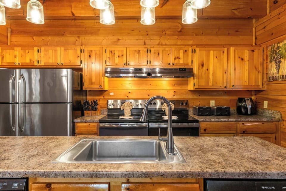 Gather around this well-equipped space with modern appliances and beautiful wood accents!