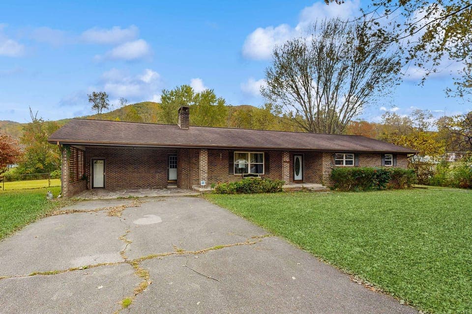 Relax on the spacious lawn with mountain views and inviting brick façade!