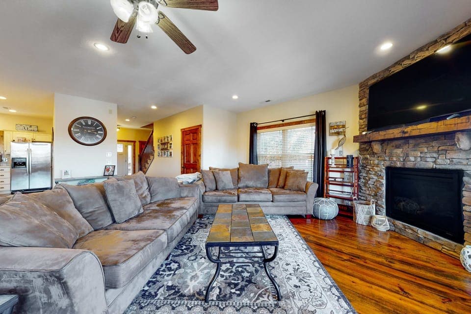 Relax in style with a spacious sectional and charming stone fireplace!