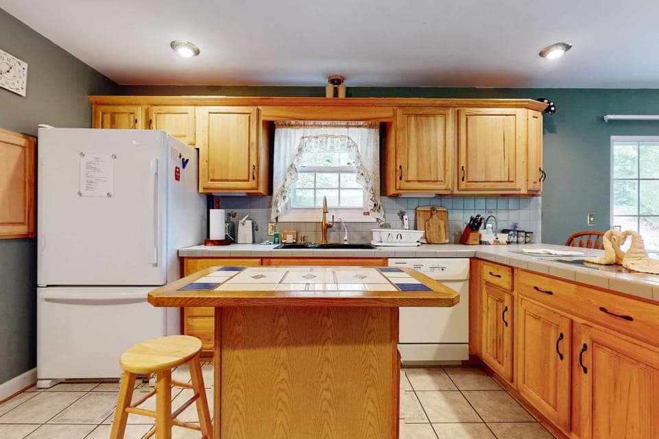 Bright and inviting with wooden cabinets, perfect for culinary adventures!