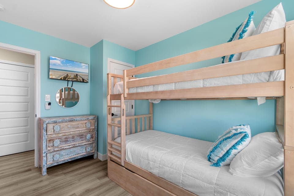 Your kids will love this cozy bunk bed room with coastal-themed decor and plenty of space to play and store their treasures.