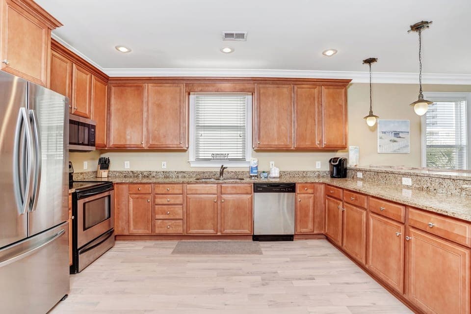 Your spacious kitchen features warm wood cabinets, granite countertops, and stainless steel appliances for memorable meal prep.