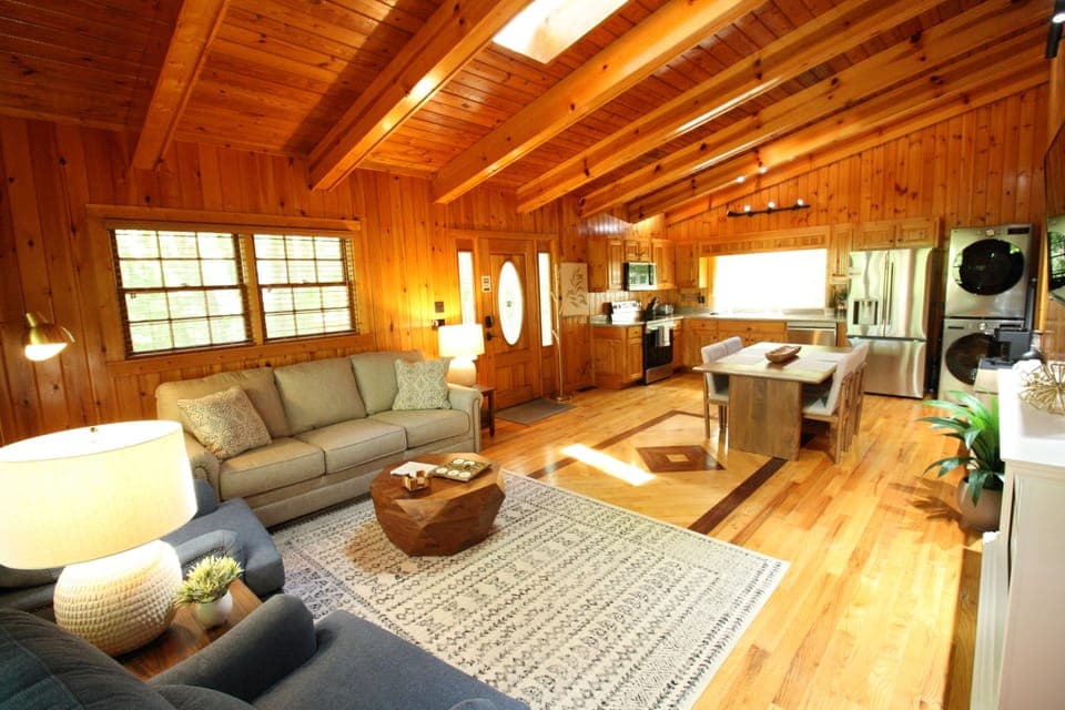 UPPER SUITE: Vaulted ceilings with skylights span the living room and kitchen, creating a bright, open space filled with natural light—perfect for relaxing and enjoying time together.